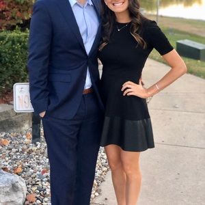 Black short sleeve dress, leather bottom.